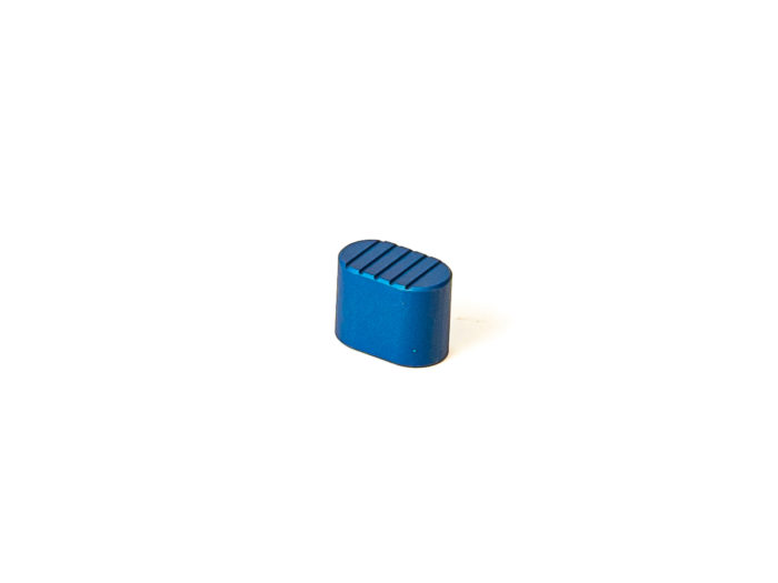 Blue metal oblong component with grooved top isolated on white background
