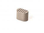 Metal oval firearm part with ridged surface on a white background