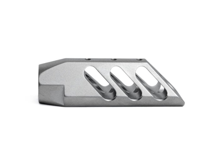 Bead blasted metal muzzle brake with angled ports on a white background