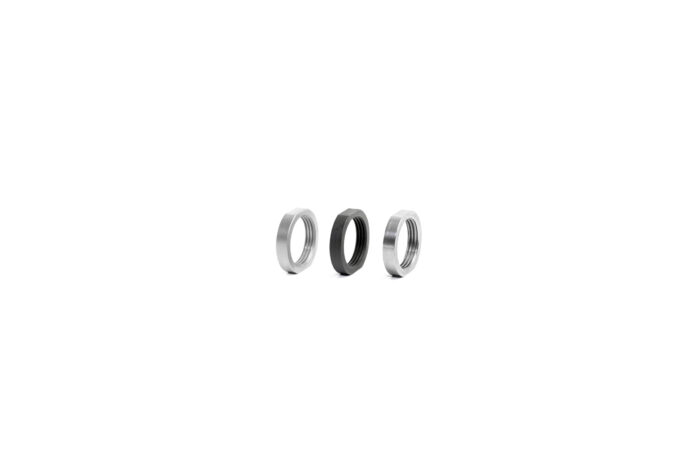 Three metal hex nuts in a row on a white background