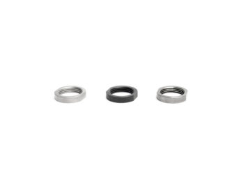 Three metal hex nuts with different finishes arranged in a row on a white background.
