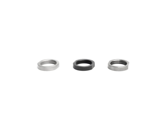 Three metal hex nuts with different finishes arranged in a row on a white background.