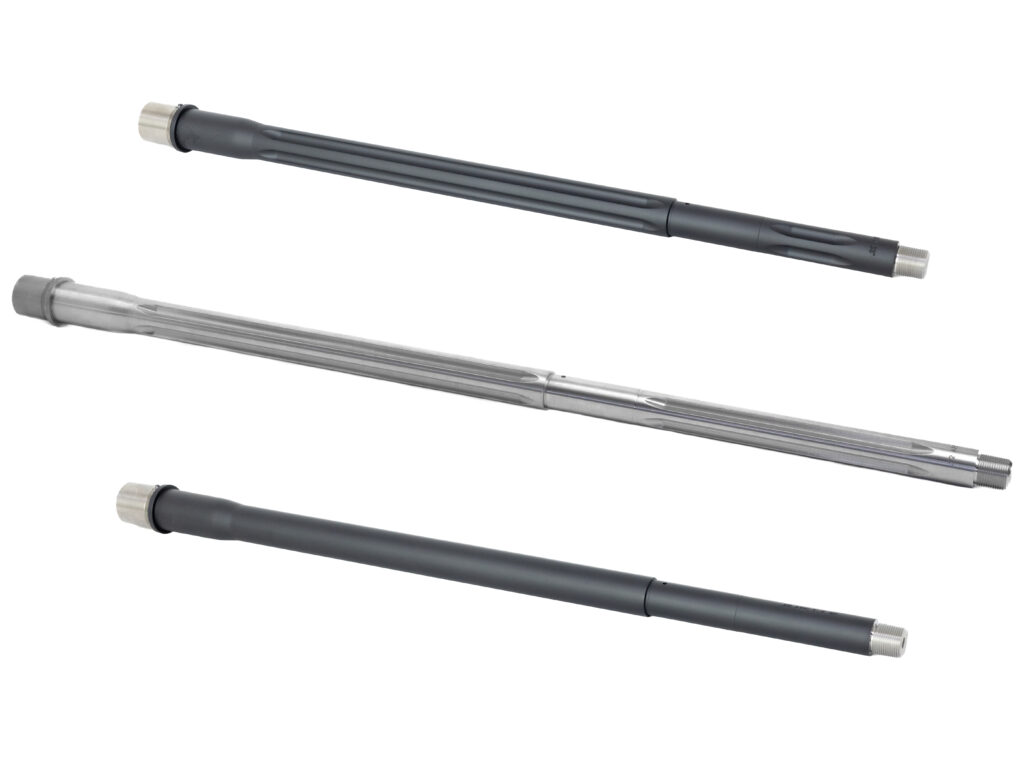Three rifle barrels with fluted and smooth finishes displayed on a white background.
