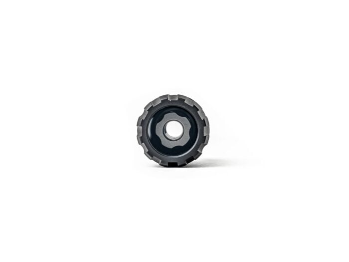 Close-up of a metal gear or knob with a textured edge on a white background.