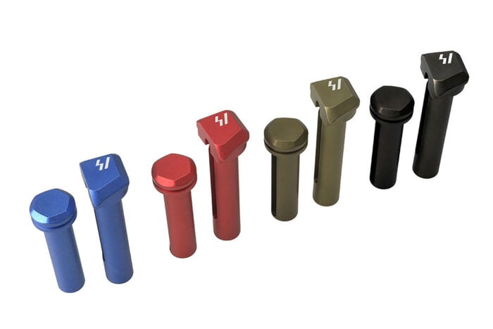 Strike Industries AR-15 extended takedown pins shown in blue, red, OD green, and black